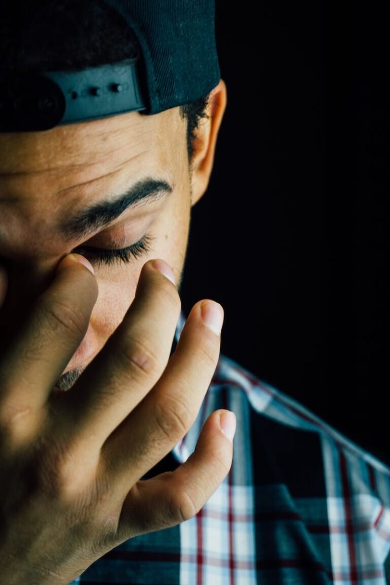 Man Pinching Nose Close-up Photo