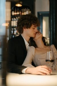 Man in Black Suit Kissing Woman in White Dress